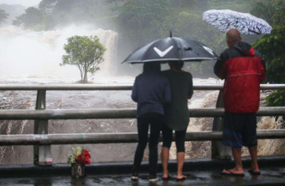 Hurricane Lane brought more than a foot of rain and flash flooding to Hawaii in 2018. <a href="https://www.gettyimages.com/detail/news-photo/people-watch-the-wailuku-river-flood-waters-on-the-big-news-photo/1022108102" rel="nofollow noopener" target="_blank" data-ylk="slk:Mario Tama/Getty Images;elm:context_link;itc:0;sec:content-canvas" class="link ">Mario Tama/Getty Images</a>