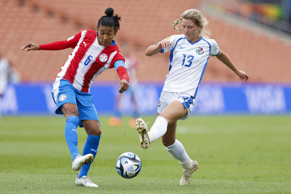 Hilda Riveros, left, of Paraguay and Riley Tanner of Panama battle for the ball during their FIFA women's World Cup qualifier in Hamilton, New Zealand, Thursday, Feb. 23, 2023. (Martin Hunter/Photosport via AP)