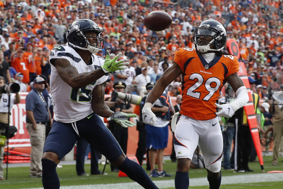 FILE - In this Sept. 9, 2018, file photo, Seattle Seahawks wide receiver Brandon Marshall, left, hauls in a touchdown pass in the end zone as Denver Broncos defensive back Bradley Roby (29) watches during the second half of an NFL football game in Denver. Marshall’s transition to life after football following the 2018 season has gone smoothly. But none of it would be possible if Marshall hadn’t realized he needed help nearly a decade ago to deal with isolation and bouts of depression. (AP Photo/David Zalubowski, File)