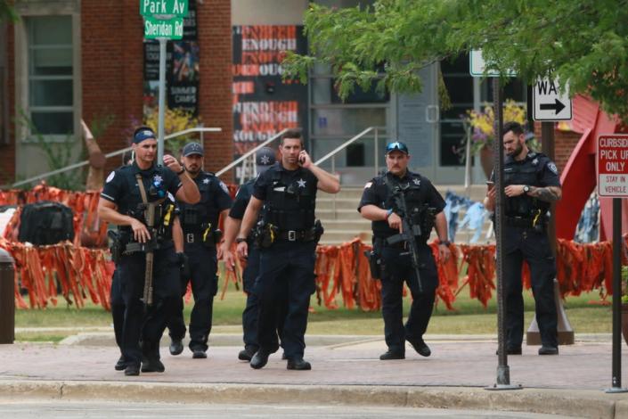 Law enforcement search the area of a shooting at a Fourth of July parade on 4 July 2022 in Highland Park, Illinois (Getty Images)