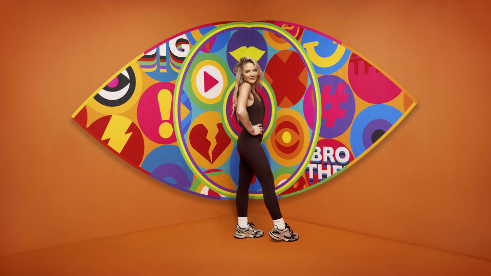 Chanelle in front of the Big Brother logo.