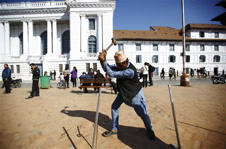 A man works to set up a polling station a day before the Constituent Assembly election in Kathmandu November 18, 2013. REUTERS/Navesh Chitrakar