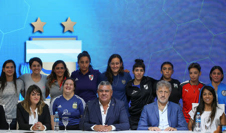 Claudio Tapia, president of the Argentine Football Association (AFA) poses for a picture next to Sergio Marchi, General Secretary of the Argentina's Footballers' Union (FAA) and players during the presentation of the women's professional soccer league, in Buenos Aires, Argentina March 16, 2019. REUTERS/Agustin Marcarian