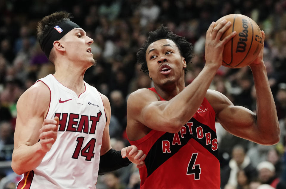 Toronto Raptors forward Scottie Barnes (4) drives past Miami Heat guard Tyler Herro (14) during the first half of an NBA basketball game Wednesday, Jan. 17, 2024, in Toronto. (Frank Gunn/The Canadian Press via AP)