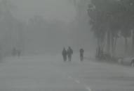 Residents walk along a street to a shelter ahead of the expected landfall of cyclone Amphan in Dhamra area of Bhadrak district, 160 km away from the eastern Indian state Odisha's capital city as the Cyclone 'Amphan' cross the Bay of Bengal Sea's eastern coast making devastation on the cyclonic weather wind and rain and make landfall on the boarder of West Bengal and Bangladesh on May 20, 2020. (Photo by STR/NurPhoto via Getty Images)