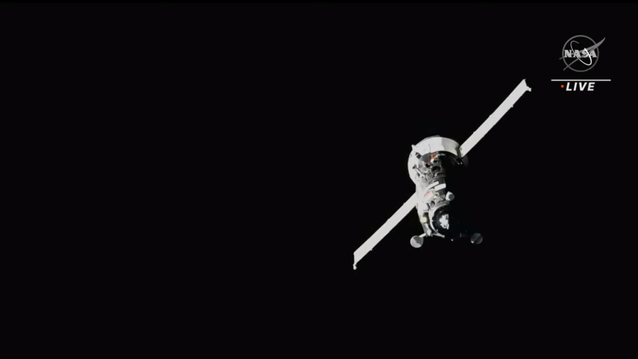  Russia's Progress 82 spacecraft with two rectangular solar wings deployed in the black of space. 