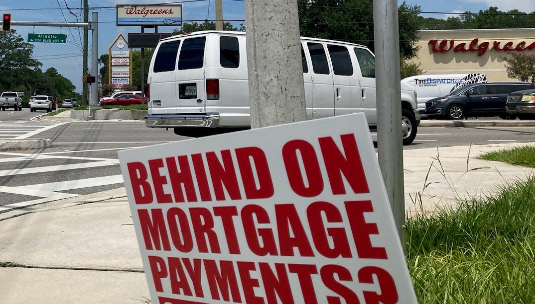 A sign on University Boulevard tries to connect with people in trouble on their mortgages. A Jacksonville-based company, American Investigative Services LLC, offered to perform forensic audits on mortgages that might identify problems. But the owner has pled guilty to wire fraud for taking customer payments and not delivering anything.