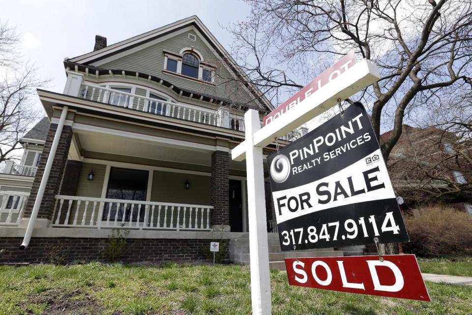 FILE - In this Tuesday, April 9, 2013 file photo, a "Sold" sign is posted outside a home in Indianapolis. Mortgage giant Freddie Mac reports quarterly results for the January-March 2014 quarter on Thursday, May 8, 2014. (AP Photo/Michael Conroy, File)