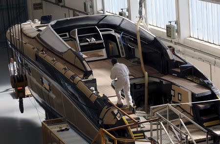 Employees work on a yacht at the Ferretti's shipyard in Sarnico, northern Italy, April 7, 2015. Picture taken on April 7, 2015. REUTERS/Stefano Rellandini