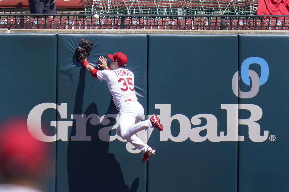 St. Louis Cardinals center fielder Lane Thomas leaps after a two-run home run by Washington Nationals' Ryan Zimmerman during the third inning of a baseball game Wednesday, April 14, 2021, in St. Louis. (AP Photo/Jeff Roberson)