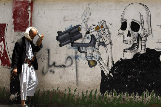 <p>A Yemeni passes a wall sprayed with anti-smoking graffiti on World No Tobacco Day in Sana’a, Yemen, May 31, 2016. World No Tobacco Day is marked annually on May 31 to raise awareness about the health risks of tobacco use and to push advocacy for policies to reduce tobacco consumption. (Yahya Arhab/EPA) </p>