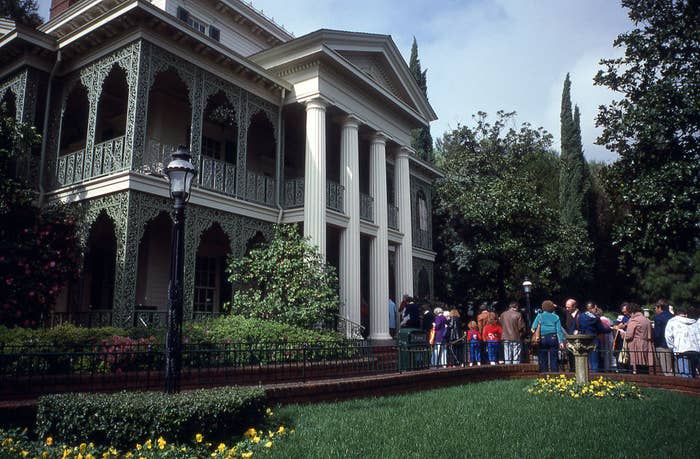 Park goers waiting in line to enter the Haunted Mansion attraction at Disneyland in 1980
