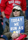 A Boston Red Sox fan holds a sign supporting the Boston Marathon runners before a baseball game between the Red Sox and Baltimore Orioles at Fenway Park in Boston Monday, April 21, 2014. (AP Photo/Winslow Townson)