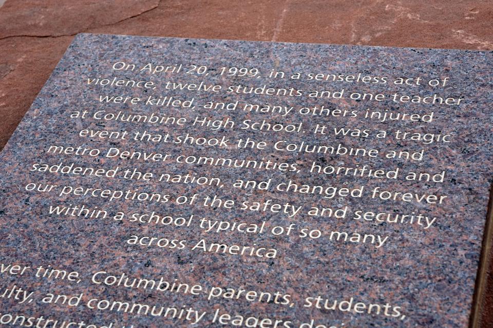 A plaque outside the Columbine memorial pays tribute to the school shooting tragedy 25 years ago.