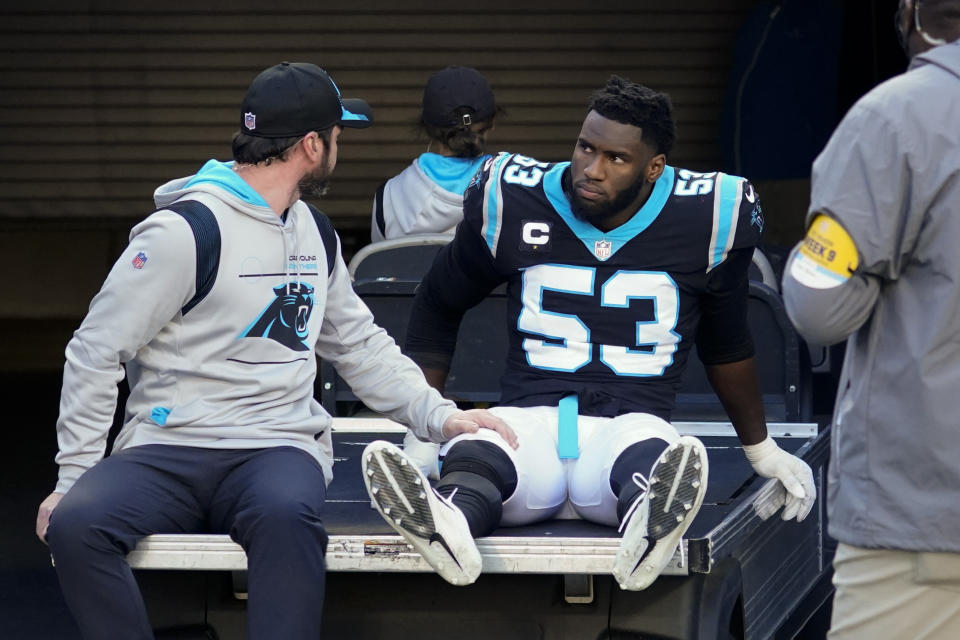 FILE - Carolina Panthers defensive end Brian Burns is taken off the field after getting hunt during the second half of an NFL football game against the New England Patriots Sunday, Nov. 7, 2021, in Charlotte, N.C. Panthers defensive end Brian Burns said he thinks Patriots quarterback Mac Jones should apologize for grabbing his foot and trying to hurt him during Sunday's game. (AP Photo/John Bazemore, File)