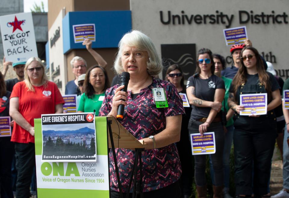Marianne Zundel, center, a registered nurse in the behavioral health unit of PeaceHealth Sacred Heart Medical Center University District, joins a rally Monday against the proposed closure of the hospital Monday.
