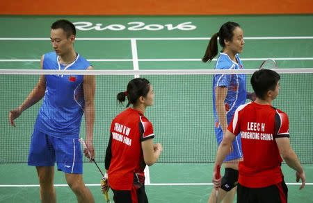 2016 Rio Olympics - Badminton - Mixed Doubles Group Play - Riocentro - Pavilion 4 - Rio de Janeiro, Brazil - 12/08/2016. Zhang Nan (CHN) of China and Zhao Yunlei (CHN) of China walk off the court along with Lee Chun Hei (HKG) of Hong Kong and Chau Hoi Wah (HKG) of Hong Kong after winning their match. REUTERS/Marcelo del Pozo