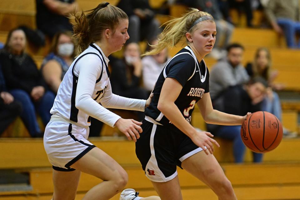 Roosevelt's Katie Keller drives on Cuyahoga Falls' Trista Lee during the first half of their game Wednesday night at Cuyahoga Falls High School.