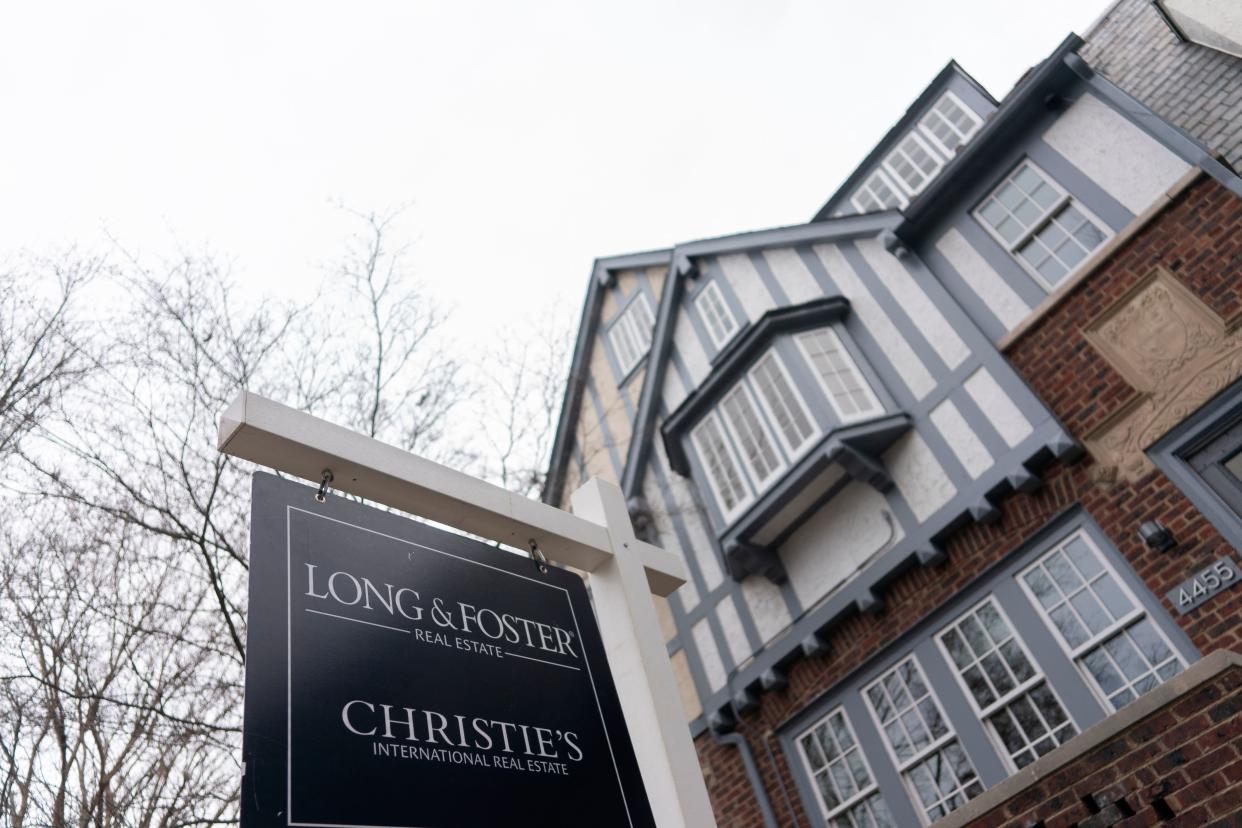 A sign for a real estate agent is posted in front of a house for sale in Washington, DC, on February 26, 2022. (Photo by Stefani Reynolds / AFP) (Photo by STEFANI REYNOLDS/AFP via Getty Images)