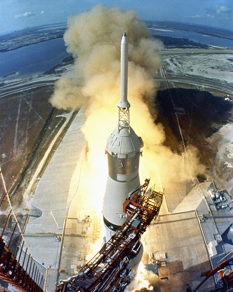 At 9:32 a.m. EDT, the swing arms move away and a plume of flame signals the liftoff of the Apollo 11 Saturn V space vehicle and astronauts Neil A. Armstrong, Michael Collins and Edwin E. Aldrin, Jr. from Kennedy Space Center Launch Complex 39A. (Photo: VCG Wilson/Corbis via Getty Images)