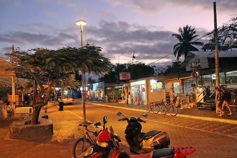 The sun sets over Puerto Ayora on Santa Cruz island - Credit: ISTOCK