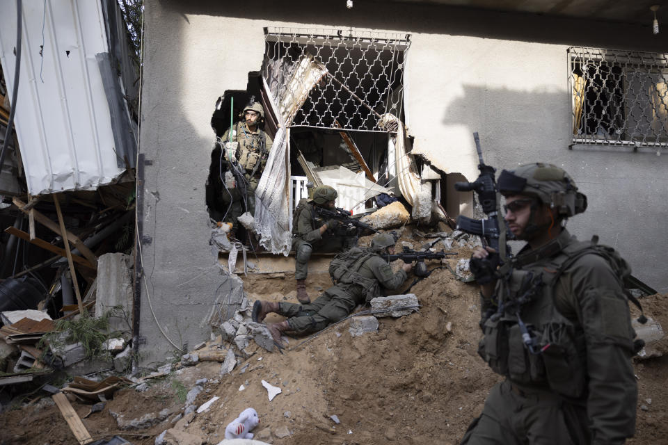 FILE - Israeli soldiers take part in a ground operation in Gaza City's Shijaiyah neighborhood, Friday, Dec. 8, 2023. The Israeli military has rounded up hundreds of Palestinians across the northern Gaza Strip, separating families and forcing men to strip to their underwear before trucking some to an undisclosed location. The roundups have laid bare an emerging tactic in Israel's ground offensive in Gaza, experts say, as the military seeks to solidify control in evacuated areas in the north and collect intelligence about Hamas operations nearly 10 weeks after the group's deadly Oct. 7 attack on southern Israel. (AP Photo/Moti Milrod, Haaretz, File)