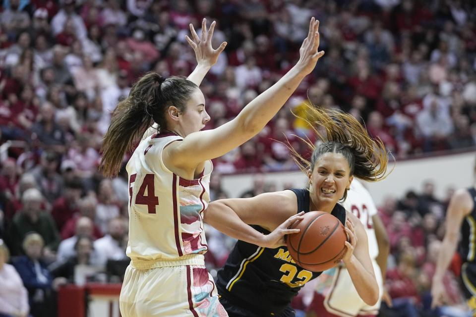 Michigan's Emily Kiser (33) goes to the basket against Indiana's Mackenzie Holmes (54) during the first half of an NCAA college basketball game Thursday, Feb. 16, 2023, in Bloomington, Ind. (AP Photo/Darron Cummings)