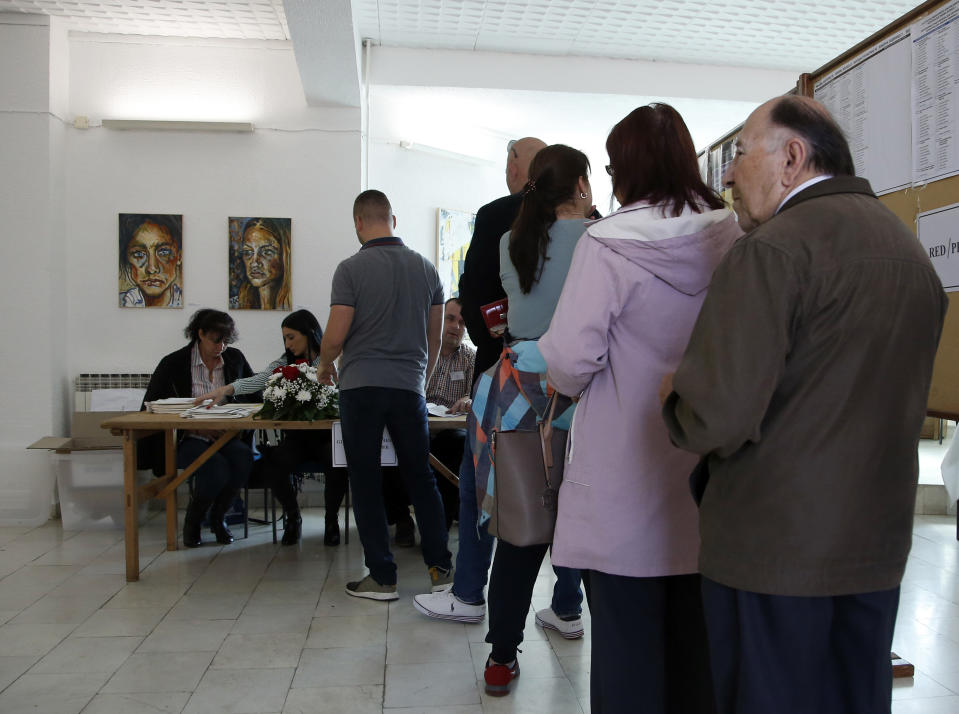 People wait in line at a polling station in Laktasi, northwest of Sarajevo, Bosnia, Sunday, Oct. 7, 2018. Bosnians were voting Sunday in a general election that could install a pro-Russian nationalist to a top post and cement the ethnic divisions of a country that faced a brutal war 25 years ago. (AP Photo/Darko Vojinovic)