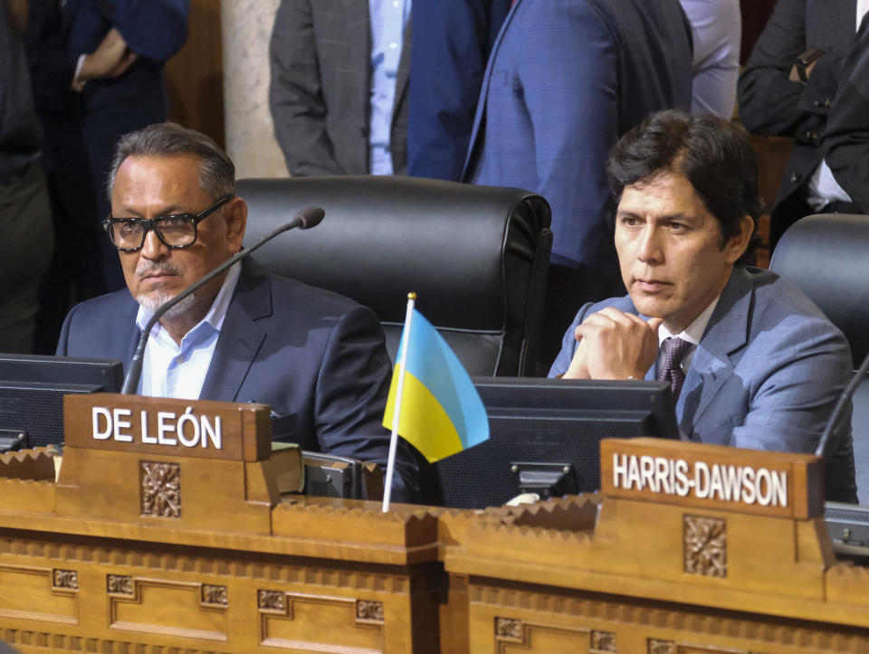 FILE - Los Angeles City Council members Gil Cedillo, left, and Kevin de Leon sit in chamber before starting the City Council meeting on Oct. 11, 2022, in Los Angeles. Two months after being entangled in a racism scandal that shook public trust in Los Angeles government, de Leon has has refused calls to resign and is attempting to rehabilitate his reputation. Cedillo, who vanished from public view shortly after the scandal emerged in October, has not attempted to return to City Hall meetings. (AP Photo/Ringo H.W. Chiu, File)