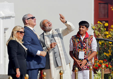 India's Prime Minister Narendra Modi flies a kite watched by his Israeli counterpart Benjamin Netanyahu and Netanyahu's wife Sara during their visit to Gandhi Ashram in Ahmedabad, India, January 17, 2018. REUTERS/Amit Dave