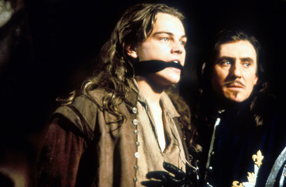 Leonardo DiCaprio with his mouth covered next to Gabriel Byrne in a scene from the film 'The Man In The Iron Mask', 1998. (Photo by United Artists/Getty Images)