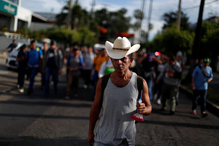 A man walks in a caravan of migrants departing from El Salvador en route to the United States, in San Salvador, El Salvador, October 28, 2018. REUTERS/Jose Cabezas