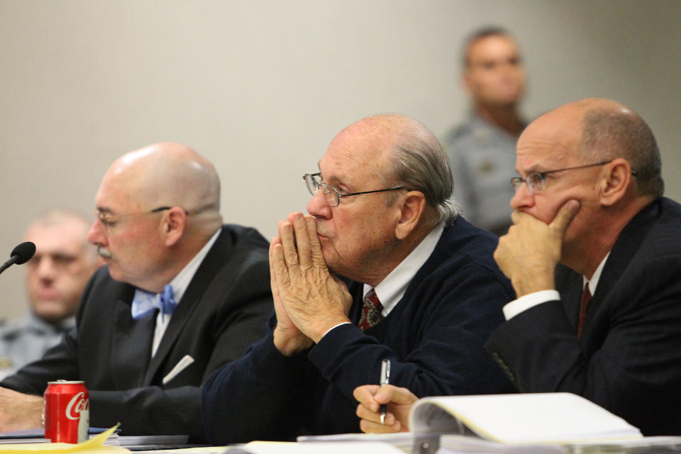 Former Tampa Police captain Curtis Reeves, Jr., center, sits beside his defense attorneys Richard Escobar, right, and Dino Michaels as they listen to his taped interview by detectives during his bond reduction hearing before Circuit Judge Pat Siracusa at the Robert D. Sumner Judicial Center in Dade City Friday, Feb. 7, 2014. Reeves is suspected of fatally shooting Chad Oulson, 43, and wounding his wife, Nicole, 33, during an argument Jan. 13 over texting at the Cobb Grove 16 theater in Wesley Chapel, Fla. (AP Photo/Pool Tampa Bay Times, Brendan Fitterer, Pool)