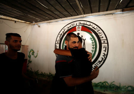 A member of Fatah movement is hugged upon his release from a Hamas-run jail as part of reconciliation efforts, in Gaza City October 1, 2017. REUTERS/Mohammed Salem