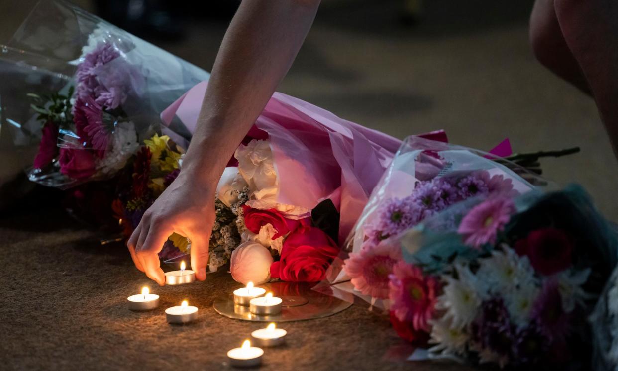 <span>People lay flowers and light candles at a church after the Nottingham attacks last year. </span><span>Photograph: Fabio De Paola/The Guardian</span>