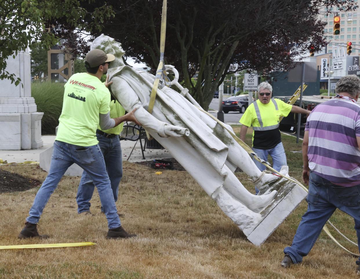 Workers remove a Christopher Columbus statue from Christopher Columbus Blvd. and Arctic Ave in Atlantic City, N.J. on Wednesday, July 1, 2020. The Christopher Columbus monument, in the resort since 1958, was taken down from its location at the base of the Atlantic City Expressway Wednesday morning.