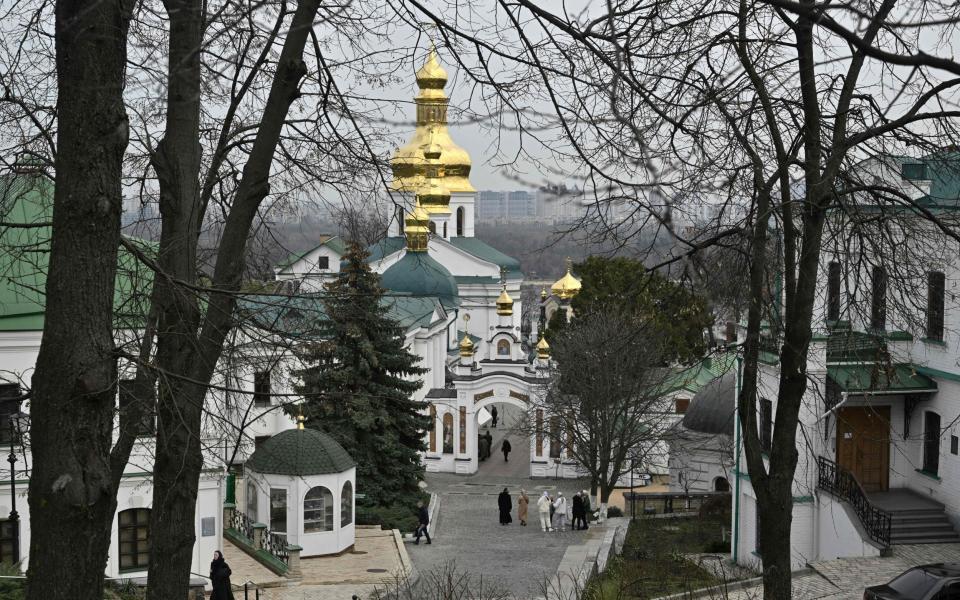 People walk at Kyiv-Pechersk Lavra, also known as the Kyiv Monastery of the Caves, a historical Eastern Orthodox Christian monastery in Kyiv, on March 24, 2023. - The aurthorities have ordered the monks to leave by March 29, 2023 the Kyiv-Pechersk Lavra, which was previously affiliated with the Russian Orthodox Church and has a crucial role in Eastern Orthodoxy but the monks say there is "no legal foundation" for an expulsion order from the government and say they plan to stay as long as possible. (Photo by Genya SAVILOV / AFP) (Photo by GENYA SAVILOV/AFP via Getty Images) - GENYA SAVILOV/AFP via Getty Images