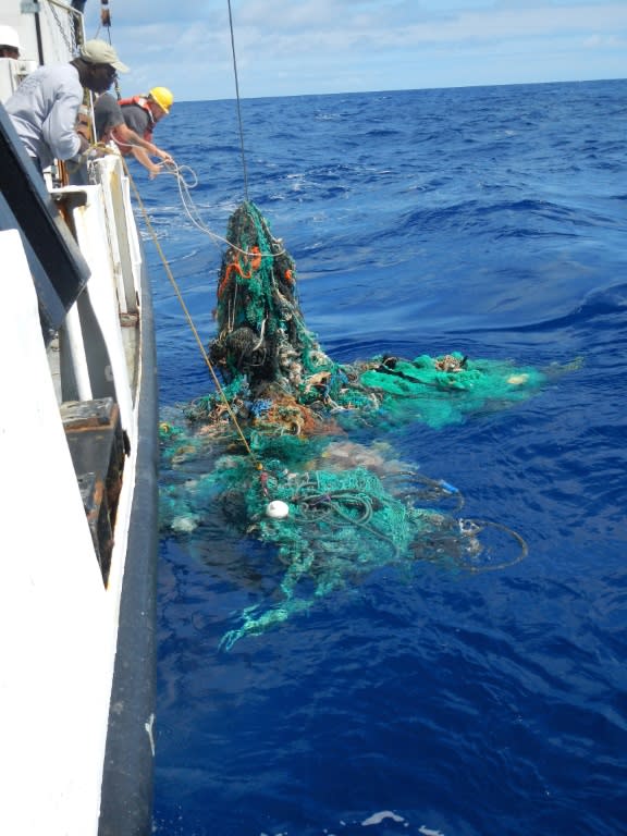 A photo released by the Ocean Cleanup Foundation shows crew pulling a ghost net from the Pacific Ocean in 2015