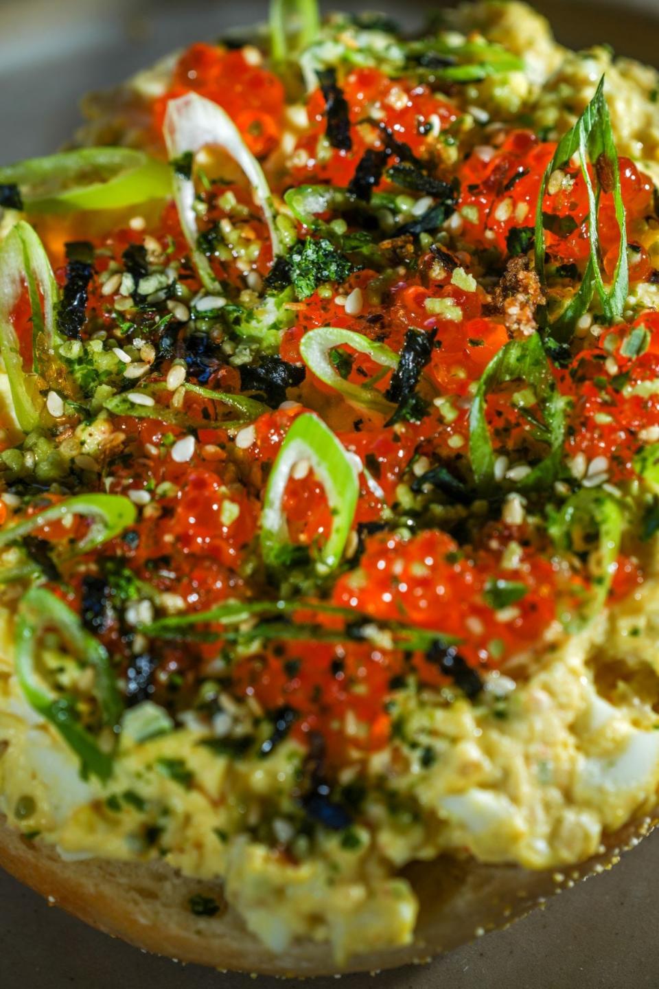 At Allie Boy’s Bagelry and Luncheonette in Walker's Point, the tamago egg salad tartine, an open-faced bagel sandwich, can be ordered  by the half ($6) or whole ($12). The egg salad is garnished with green onion and seasoned with furikake; optional trout roe is $3.