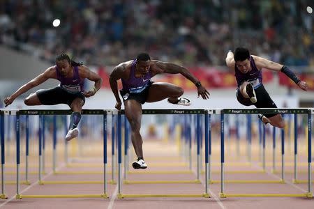 David Oliver of the U.S (C) competes to win alongside Aries Merritt (L) of the U.S and Xie Wenjun of China during the men's 110m hurdles at the IAAF Diamond League Athletics in Shanghai May 17, 2015. REUTERS/Aly Song