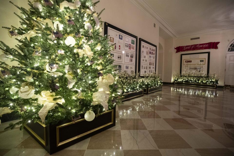 The First Family's annual ornament, the American flag, decorates a tree during the 2019 Christmas preview at the White House, Monday, Dec. 2, 2019, in Washington. (AP Photo/Alex Brandon)