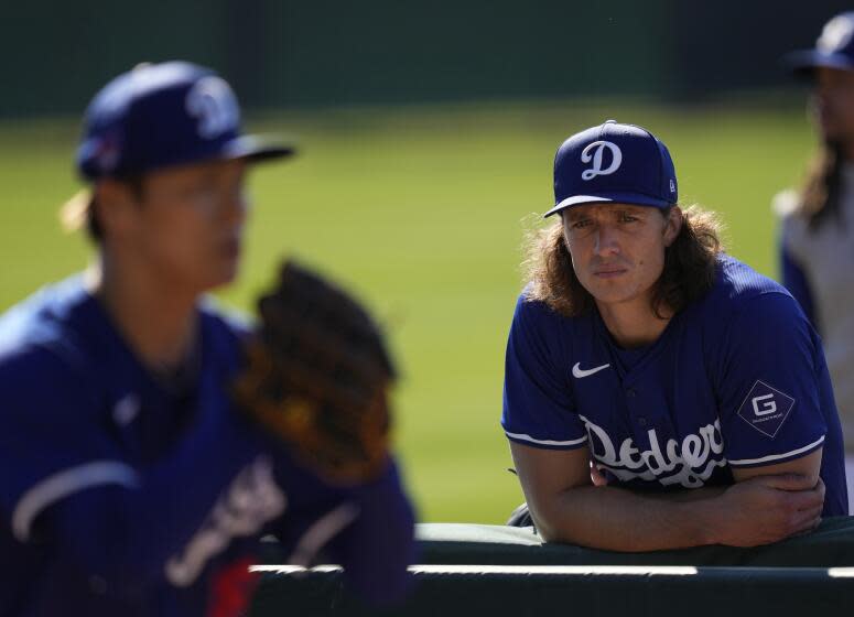 Los Angeles Dodgers pitcher Tyler Glasnow, right, watches as teammate Yoshinobu Yamamoto.