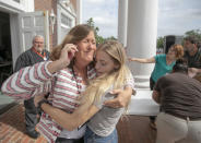 <p>Judge Sarah Ritterhoff Williams embraces family friend student Attie French after finding her in the crowd at First Baptist Church while looking for her own daughter following a shooting at Forest High School, Friday 20, 2018 in Ocala, Fla. (Photo: Alan Youngblood/Star-Banner via AP) </p>