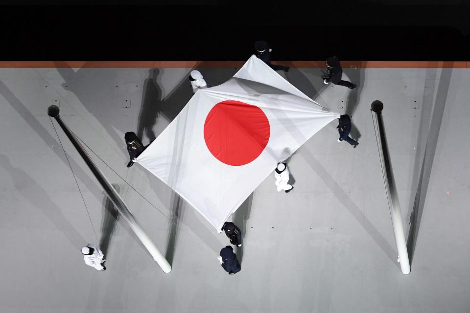 Japan's flag is carried onto the stage during the opening ceremony.