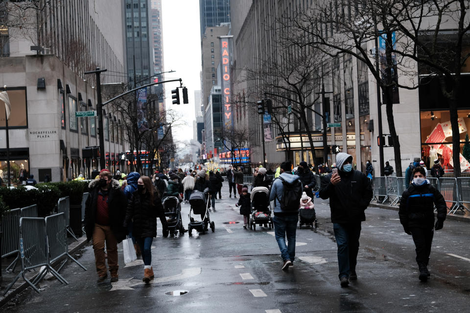 NEW YORK, NEW YORK - DECEMBER 20: People walk through Rockefeller Center on the last Sunday before Christmas on December 20, 2020 in New York City. Rockefeller Center, where the annual Christmas tree is displayed among other holiday attractions, has far less crowds this year and numerous restrictions due to the ongoing COVID-19 pandemic. New York City has seen a slow uptick in COVID hospitalizations over the last few weeks but is still far below the numbers witnessed in the spring. (Photo by Spencer Platt/Getty Images)