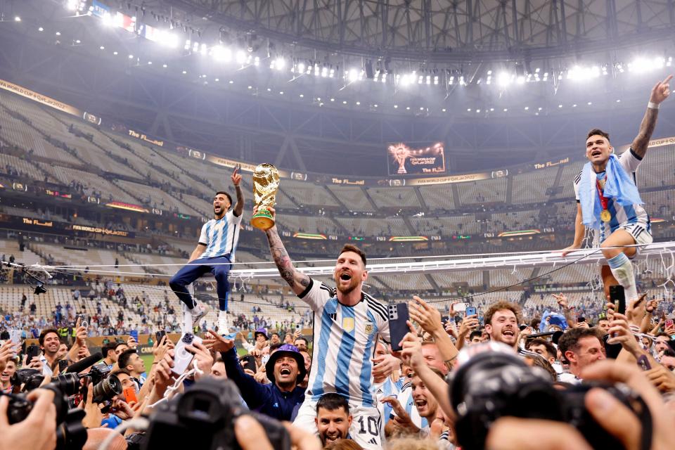 Argentina players carry Lionel Messi on their shoulders after winning the 2022 World Cup final against France at Lusail Stadium.