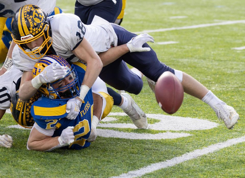 Kirtland’s Will Beers tackles Marion’s Darren Meier after teammate Macquire Boyd stripped the ball loose in the Division VI state final, Saturday, Dec. 3, 2022, at Tom Benson Hall of Fame Stadium. Boyd recovered the fumble.