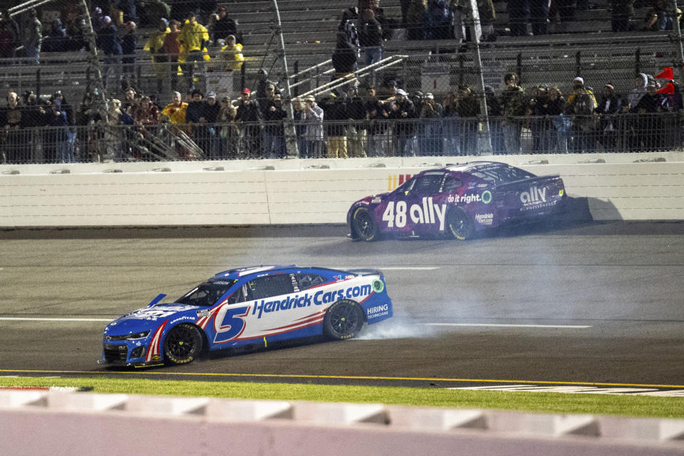 Kyle Larson (5) spins out as Alex Bowman (48) drives up high to avoid contact during a NASCAR Cup Series auto race at Richmond Raceway on Sunday, March 31, 2024, in Richmond, Va. (AP Photo/Mike Caudill)