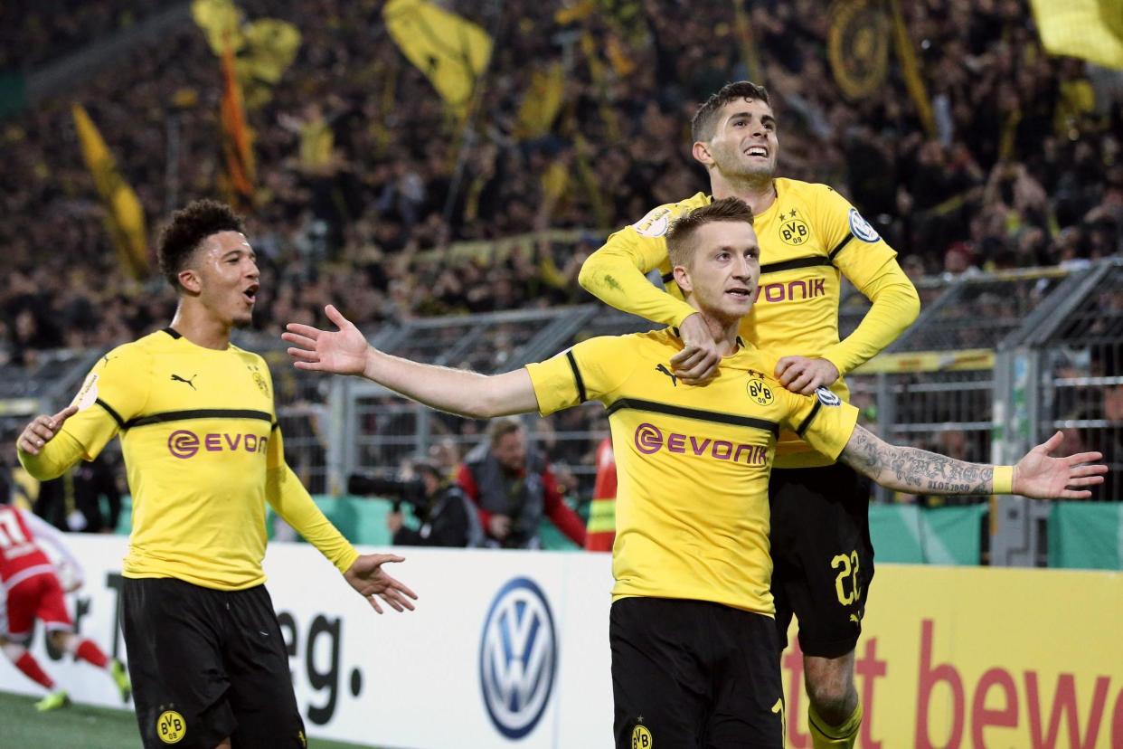 Sancho (left) and Pulisic (right) celebrate with Marco Reus (centre): Bongarts/Getty Images
