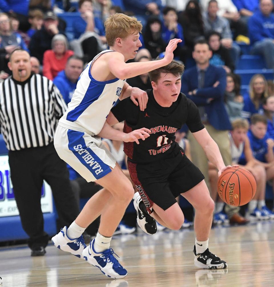 Conemaugh Township's Tanner Shirley looks to drive around Windber defender Caden Dusack, left, during a WestPAC boys basketball contest, Thursday, in Windber.